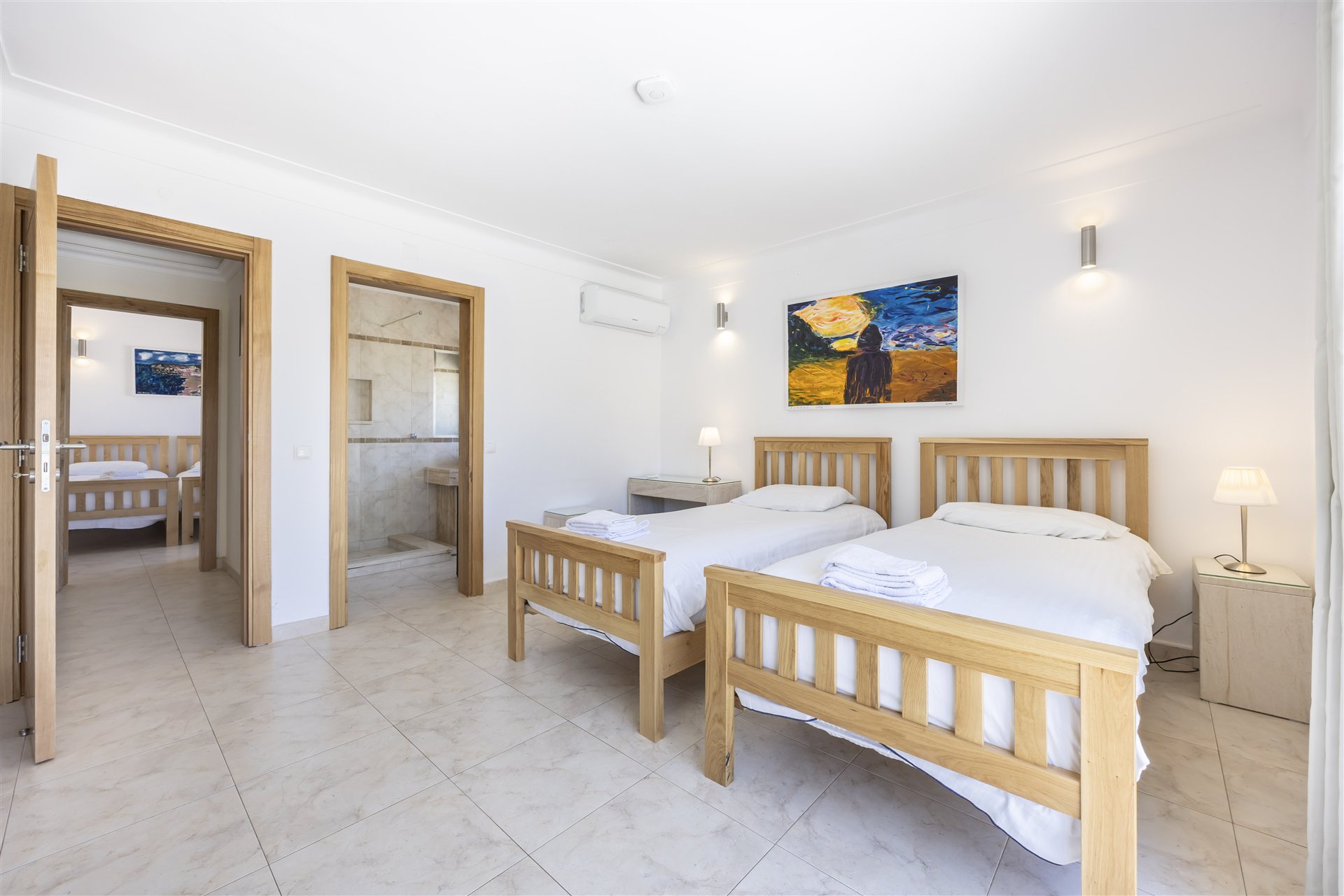 Twin en-suite bedroom with artwork