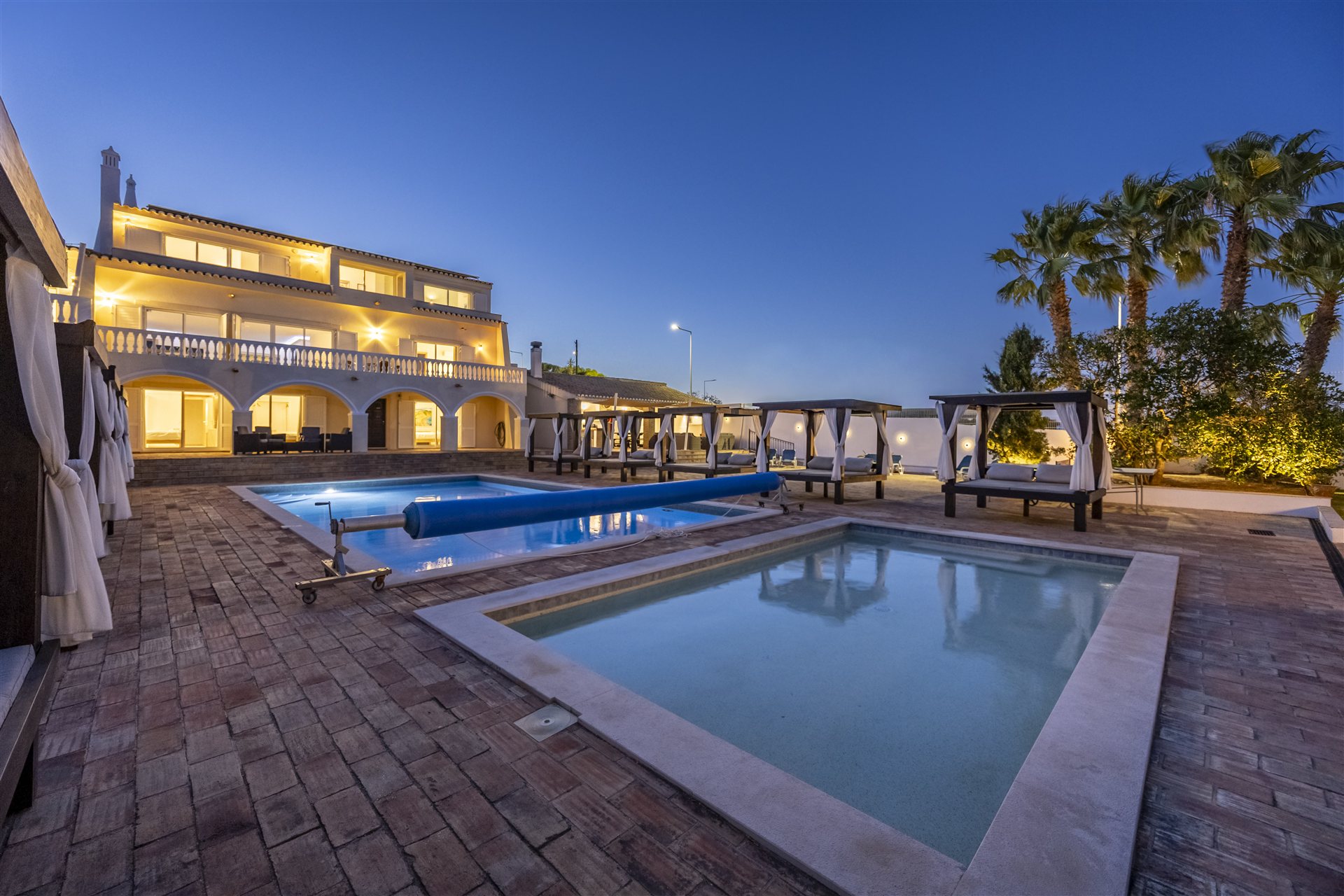 The villa and both pools at dusk