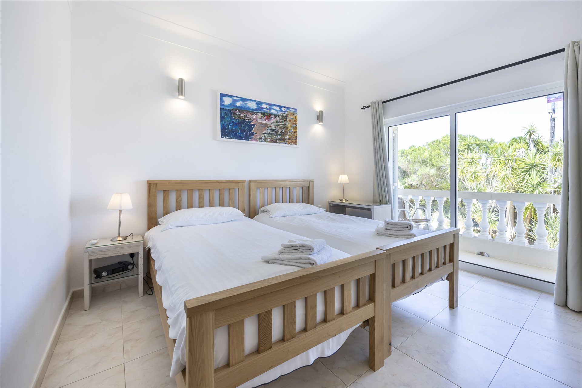 Twin bedroom opening onto a balcony